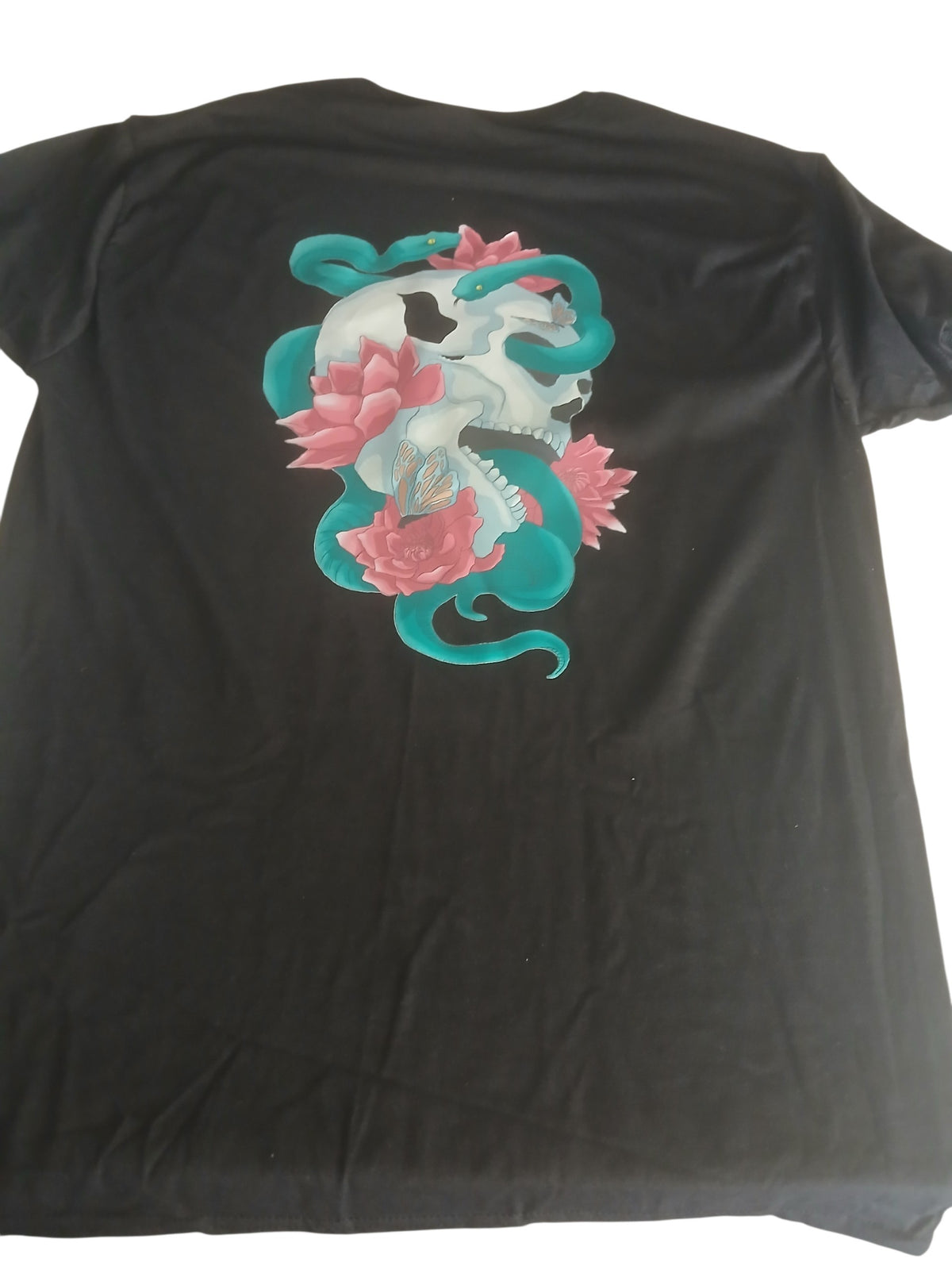 Venomous Volare black cotton t-shirt featuring a back graphic of a skull, teal serpent, and pink lotus flowers.