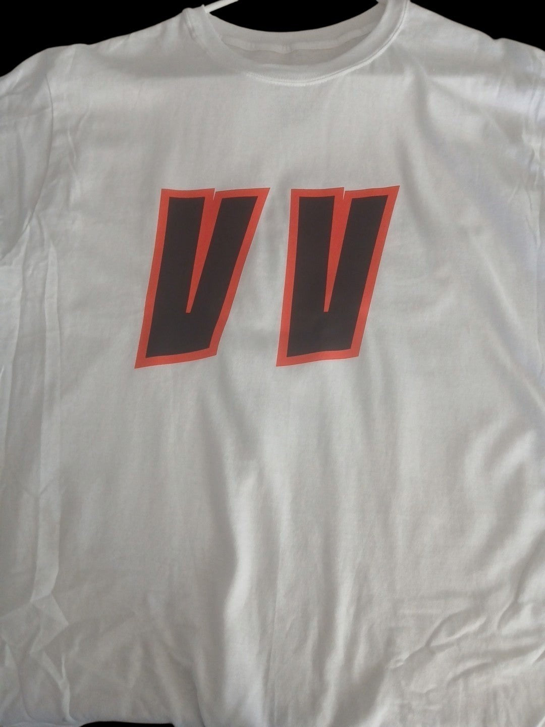 Venomous Volare white crew neck t-shirt featuring a bold red and black typographic VV graphic on the front